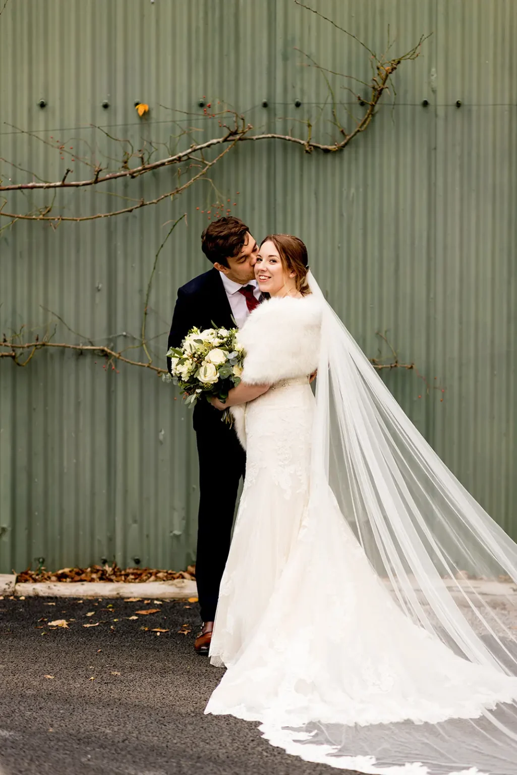 Couple dressed for their winter wedding at Clock Barn
